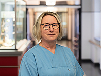 Frau mit kinnlangen blonden Haaren im Flur